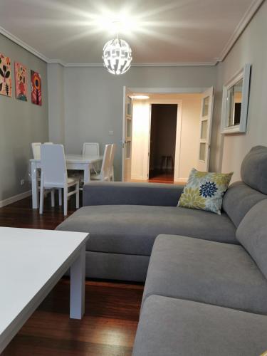 a living room with a couch and a table at Playa Home Noja in Noja