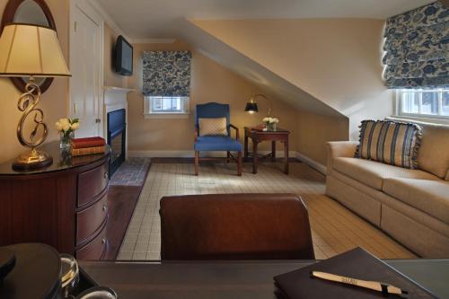 a living room with a couch and a chair at Inn on Boltwood in Amherst