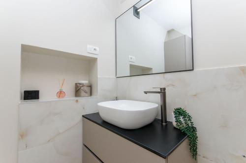 a bathroom with a white sink and a mirror at Rio Luxury Rooms in Split