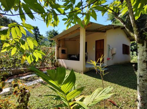 a small house in the middle of a garden at Chalés Bela Vista in Paraty