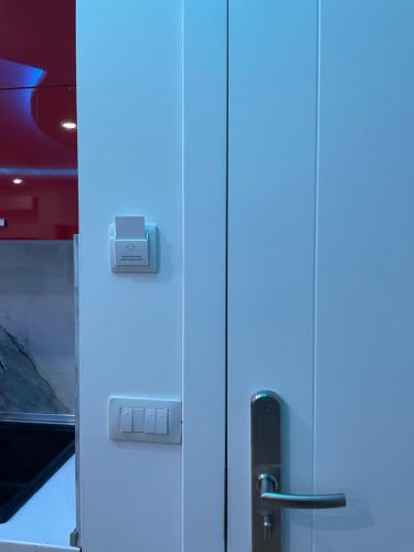 a white cabinet with a blue door at Suite Rana Hedhun in Shëngjin