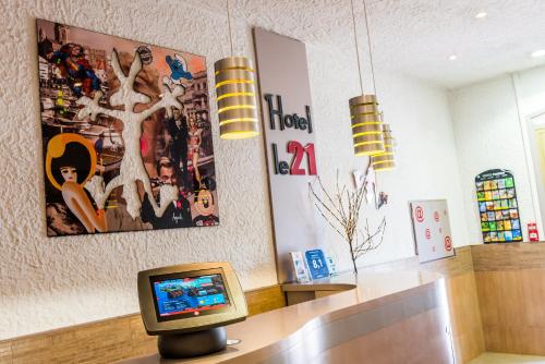 a tv sitting on top of a desk in a room at Hotel Le 21 in Saint-Raphaël
