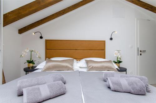 a bedroom with a white bed with two pillows at Rio Luxury Rooms in Split