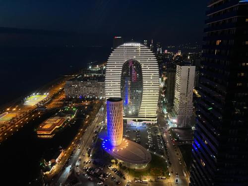uma vista nocturna de uma cidade com um edifício alto em Lika's Apartment em Batumi