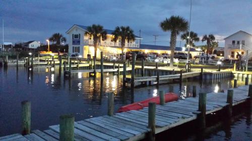 a dock with a boat in the water at night at Waterway Inn in Cedar Point