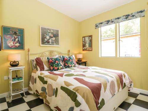 a bedroom with a bed and a window at Lulu Logs in Bristol
