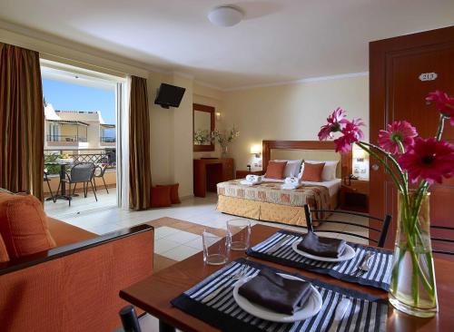 a hotel room with a bed and a living room at Avantis Suites Hotel in Eretria