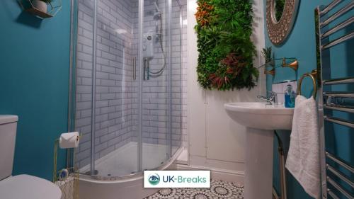 a bathroom with a shower and a sink at The historic Bulls Head-Grade II Listed in Chapel en le Frith