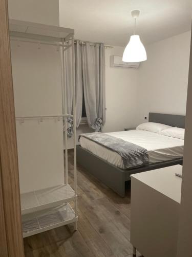 a small bedroom with a bed and a mirror at A casa di NENÉ BeB in Lesina