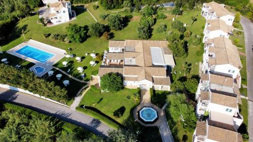 an aerial view of a house with a swimming pool at Rebecca's Village Corfu Hotel in Karousádes