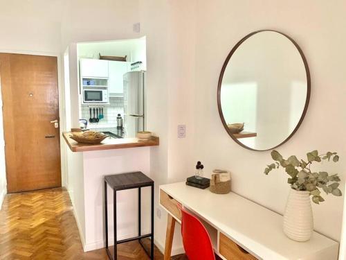 a bathroom with a counter with a mirror and a table at flat in Buenos Aires in Buenos Aires