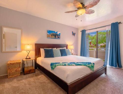 a bedroom with a bed and a ceiling fan at Ideal Coconut Coast Condo in Kapaa