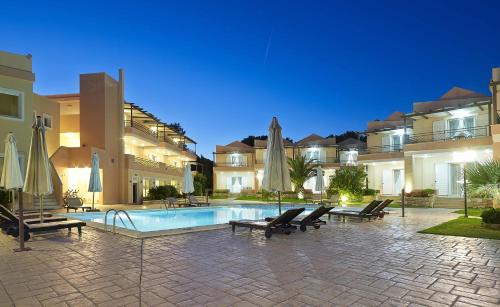 a courtyard with a swimming pool in front of some buildings at Avantis Suites Hotel in Eretria