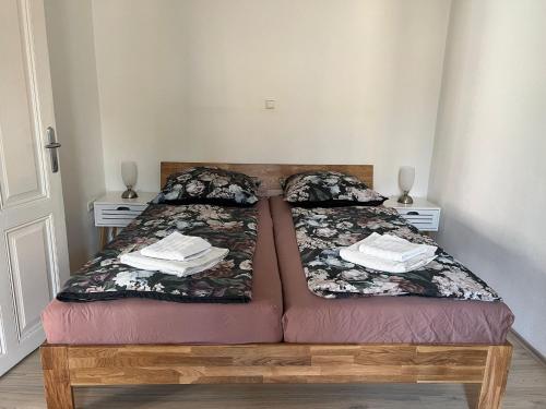 a bed in a room with two tables and a bedspread at Zentrale Lage in Bad Ischl - Top 2 in Bad Ischl