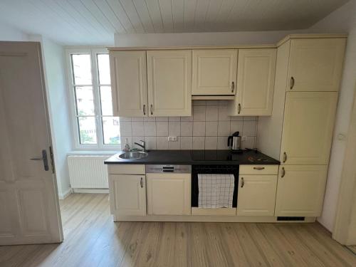 a kitchen with white cabinets and a sink at Zentrale Lage in Bad Ischl - Top 2 in Bad Ischl