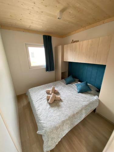 a teddy bear sitting on a bed in a room at Beach House Mane Sol - Perfect Seafront House For Relaxing Holidays in Drage