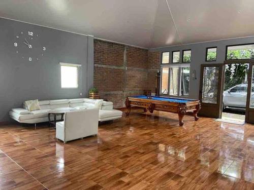 a living room with a pool table in it at La casa de luz in Concepción de Ataco