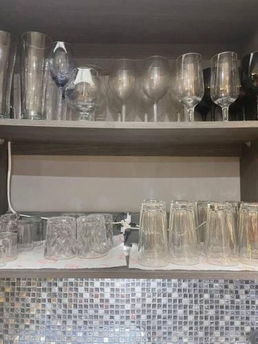 a bunch of glasses sitting on a shelf at La casa de luz in Concepción de Ataco