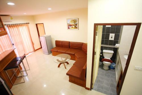 a living room with a couch and a toilet at Noppakao Place in Chiang Mai