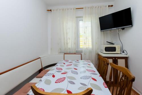 a small room with a table and a microwave at Apartments Marija I in Lopar