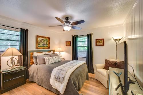 a bedroom with a bed and a ceiling fan at Whimsical Athens Home - 3 Mi to Sanford Stadium in Athens