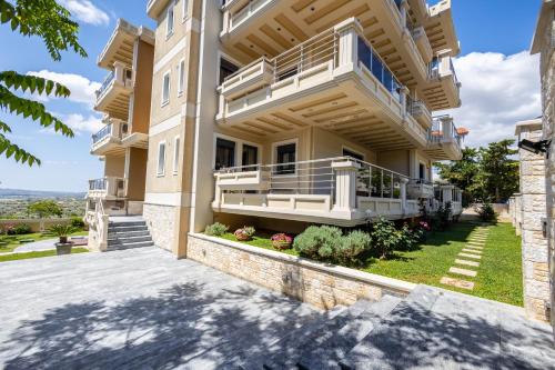 a large house with a balcony and a yard at Thea Apartment_Athens Airport in Spáta