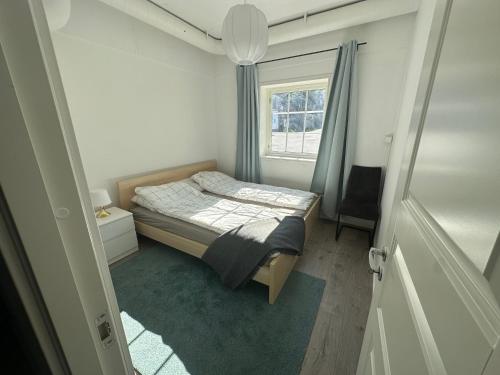 a small bedroom with a bed and a window at Den Vesle Sjarmøren As The most central place in Årdal ! Free Parking on the site ! in Årdal