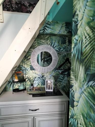 a bathroom with a dresser and a staircase with a mirror at DobraNoc in Łódź