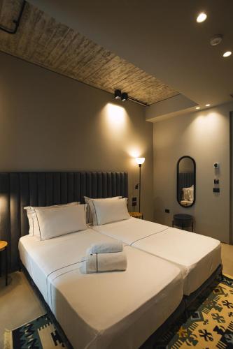 a bedroom with a large white bed in a room at Dot Tradition in Vlorë