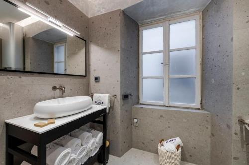 a bathroom with a sink and a mirror at Flora-heartbeat old city three bedrooms apartment in Dubrovnik