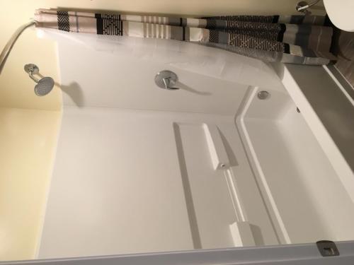 a close up of a bath tub with a sink at Lincoln Park Motel in Los Angeles