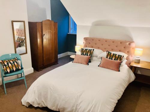 a bedroom with a large white bed and a chair at Sunderland Stays, Romford, Luxury House - City Centre & Hospital in Sunderland