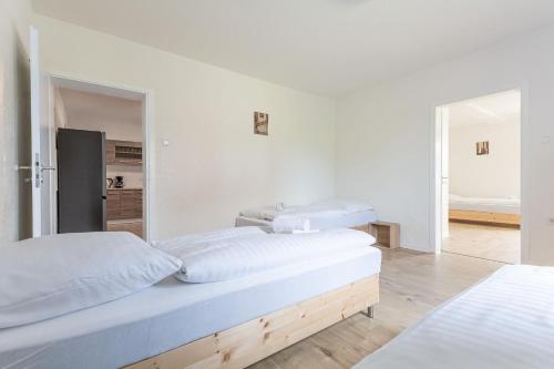 a bedroom with two beds and a mirror at T&K Apartments Wegberg 5 Monteur Apartments in Wegberg