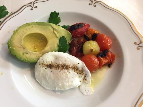 a plate of food with an egg and vegetables at The Nutmeg Vermont in Wilmington