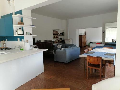 cocina y sala de estar con mesa y sofá en Delizioso Open Space da Letizia, en Pomezia