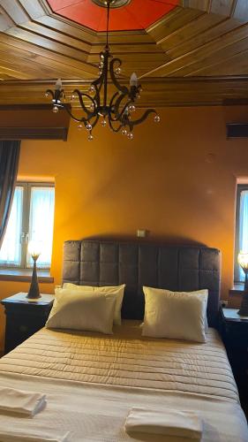 a bedroom with a large bed with a chandelier at Eleatis in Margarítion