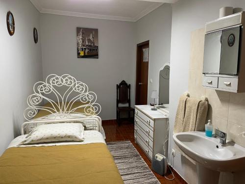 Baño blanco con cama y lavabo en Residencia do Norte, en Lisboa