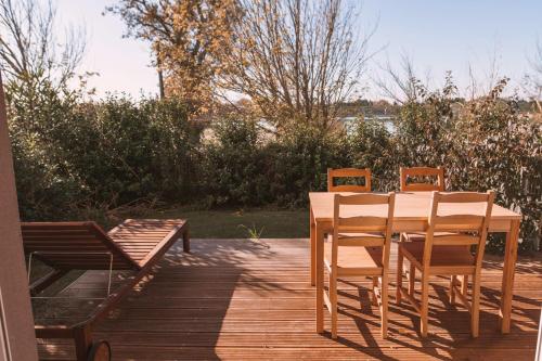 une table et des chaises en bois sur une terrasse dans l'établissement Studio with breathtaking view of Lake Monteux, à Monteux