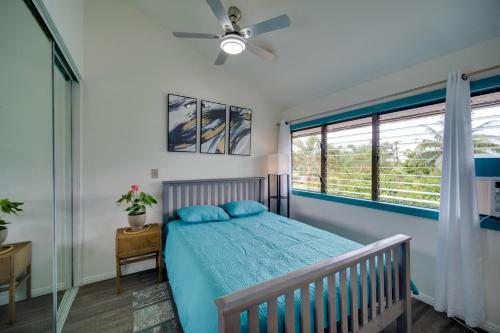 a bedroom with a bed and a ceiling fan at Kauai Vacation Rental Walk to Kalapaki Beach! in Lihue