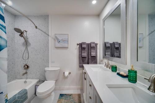 a bathroom with a toilet and a sink and a tub at Kauai Vacation Rental Walk to Kalapaki Beach! in Lihue