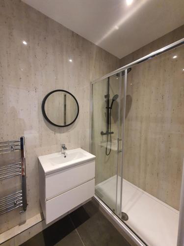 a bathroom with a sink and a shower at Marble House in Edgware