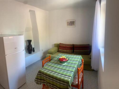a kitchen with a table with a bowl of fruit on it at la côte magique in Orebić