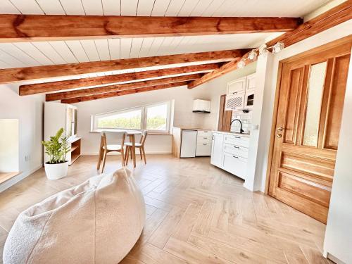 a kitchen and dining room with a table and chairs at Gackowo in Ostróda