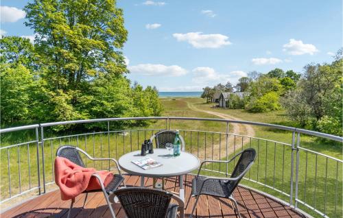 a patio with a table and chairs on a balcony at Holiday Home Frederikshavn 52 Denmark in Sæby