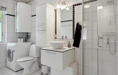 a bathroom with a toilet and a sink and a shower at Holiday Home Frederikshavn 52 Denmark in Sæby