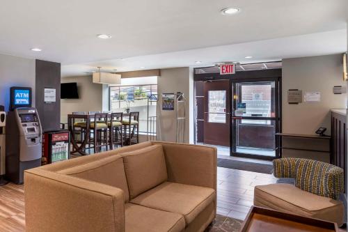 a living room with a couch and a restaurant at Best Western Brooklyn-Coney Island Inn in Brooklyn