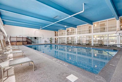 une grande piscine avec un plafond bleu dans l'établissement Suburban Studios Pueblo North, à Pueblo