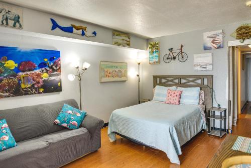 a bedroom with a bed and a couch at Ocean Jewels Resort Studio with Community Perks! in Daytona Beach