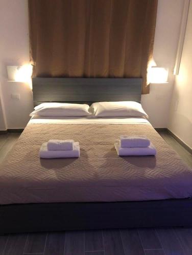 Dos toallas en una cama con dos almohadas. en Fuori Ortigia Room 2, en Siracusa