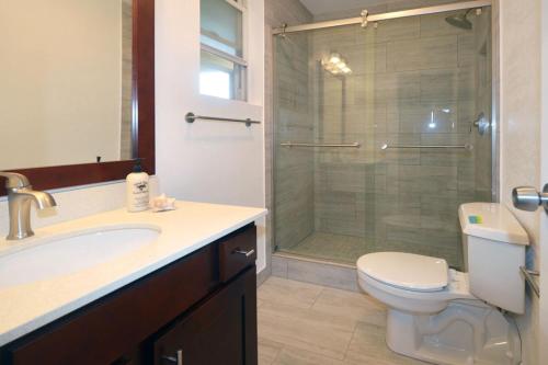 a bathroom with a shower and a toilet and a sink at Kuhio Shores 416 in Koloa
